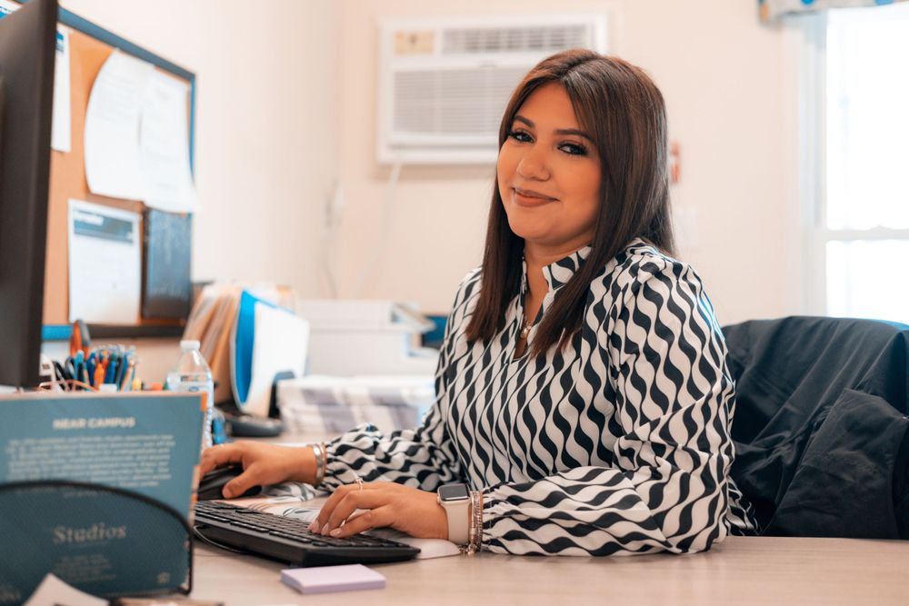 Person working on laptop computer in comfortable home office setting.