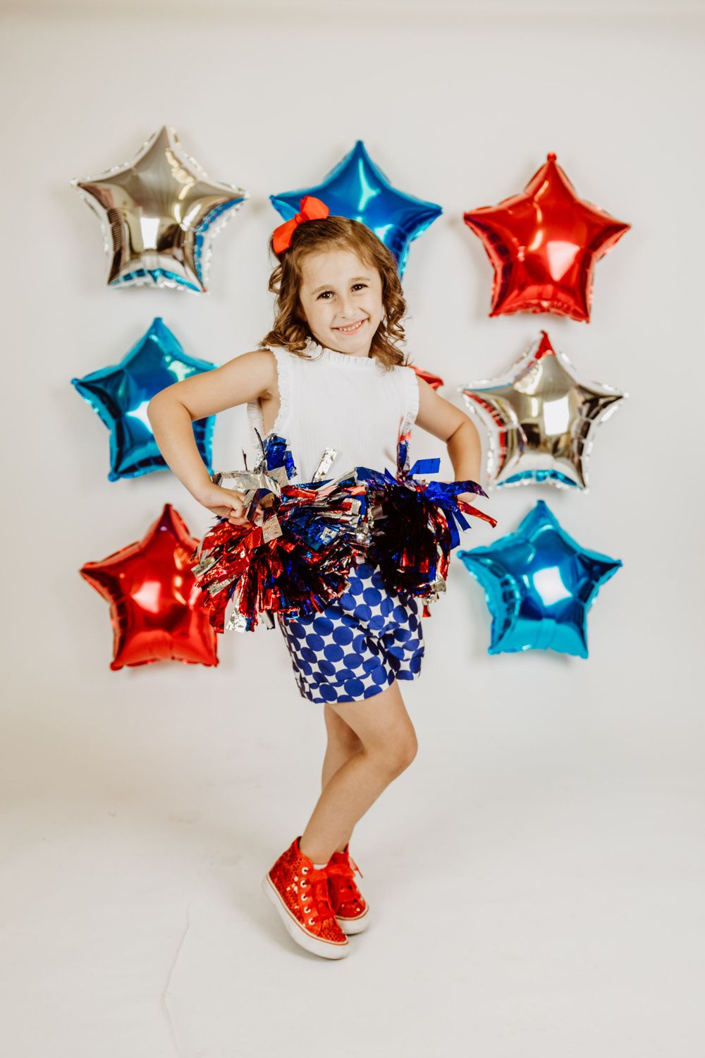 Festive patriotic outfit with star balloons and sparkly decorations.