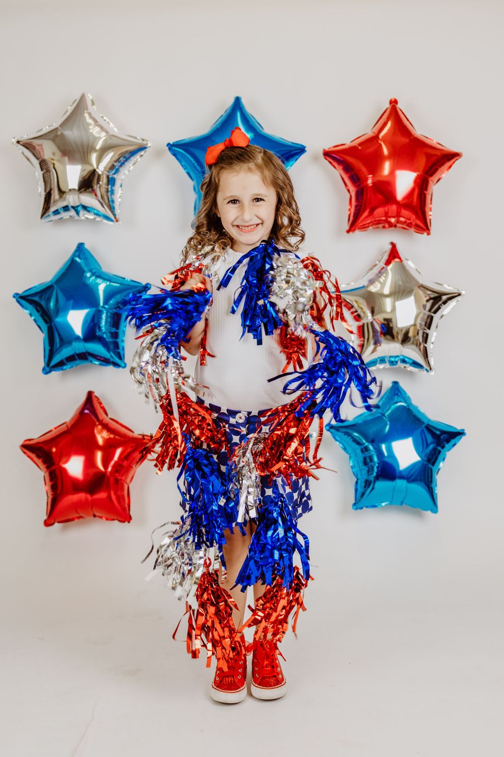 Festive celebration with tinsel and star balloons in red white and blue.