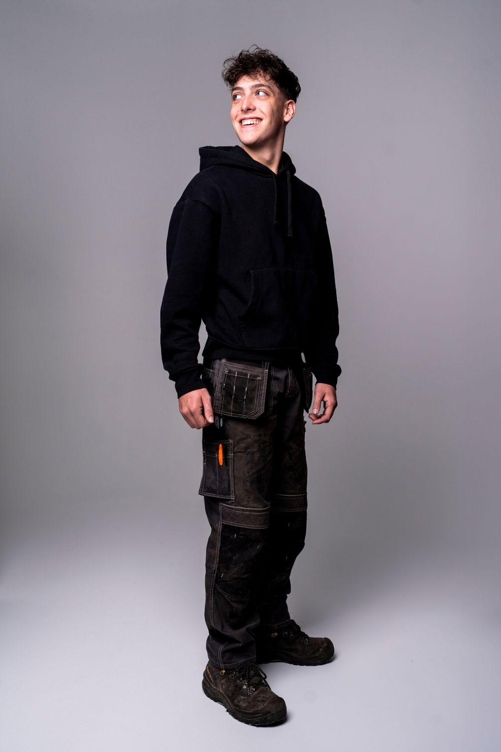 Studio portrait sequence showing a person in black clothing against a gray background.