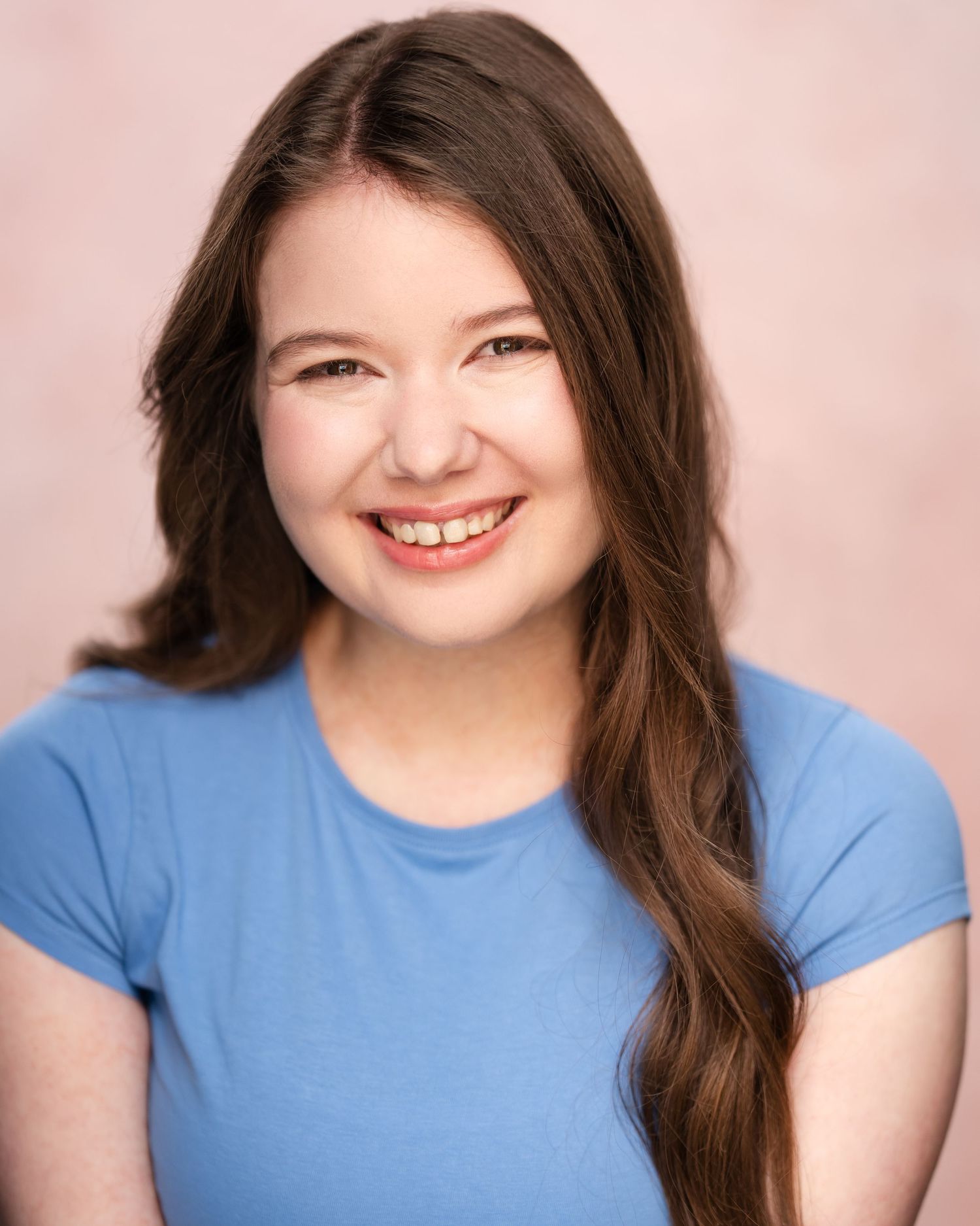 Professional headshot of person in green top with long blonde hair against blurred background in Guildford, Surrey.