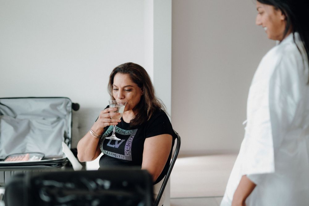 Someone getting professional makeup done while seated in a bright room.