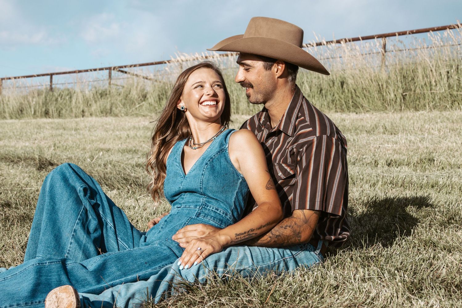 A candid moment of laughter captured between a couple in casual attire.