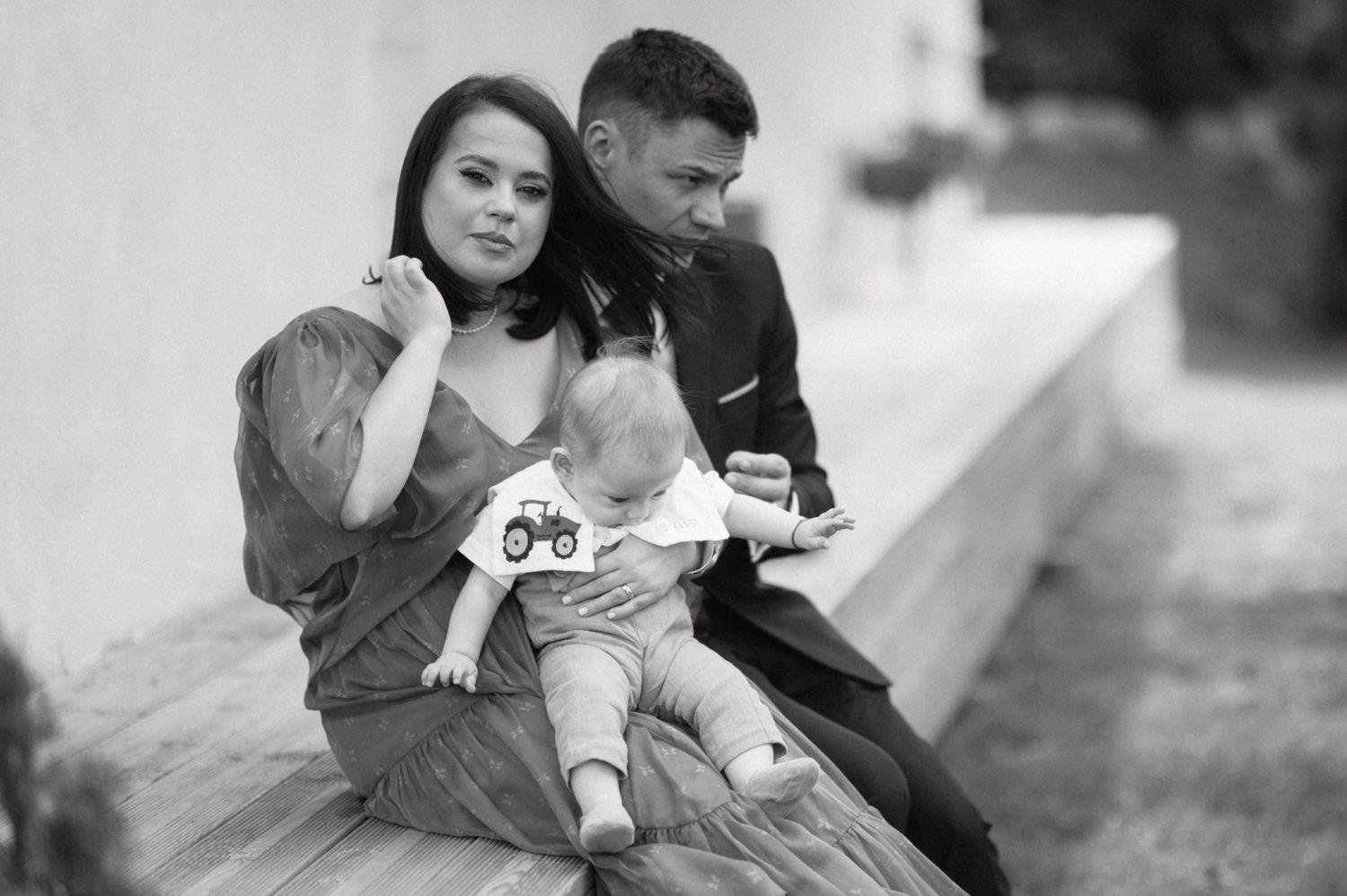 A black and white family portrait taken outdoors.