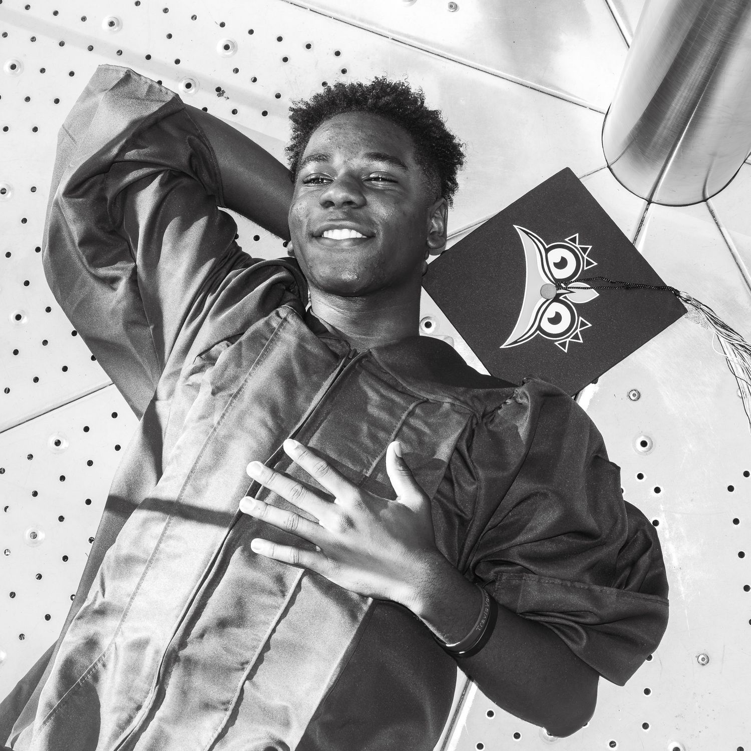 A black and white collage of candid portraits showing joyful expressions and laughter in a casual setting.