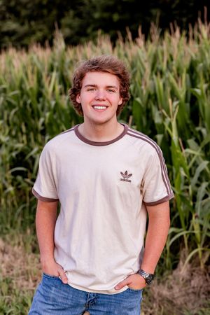 A series of five casual outdoor portraits in a white t-shirt against a cornfield background.