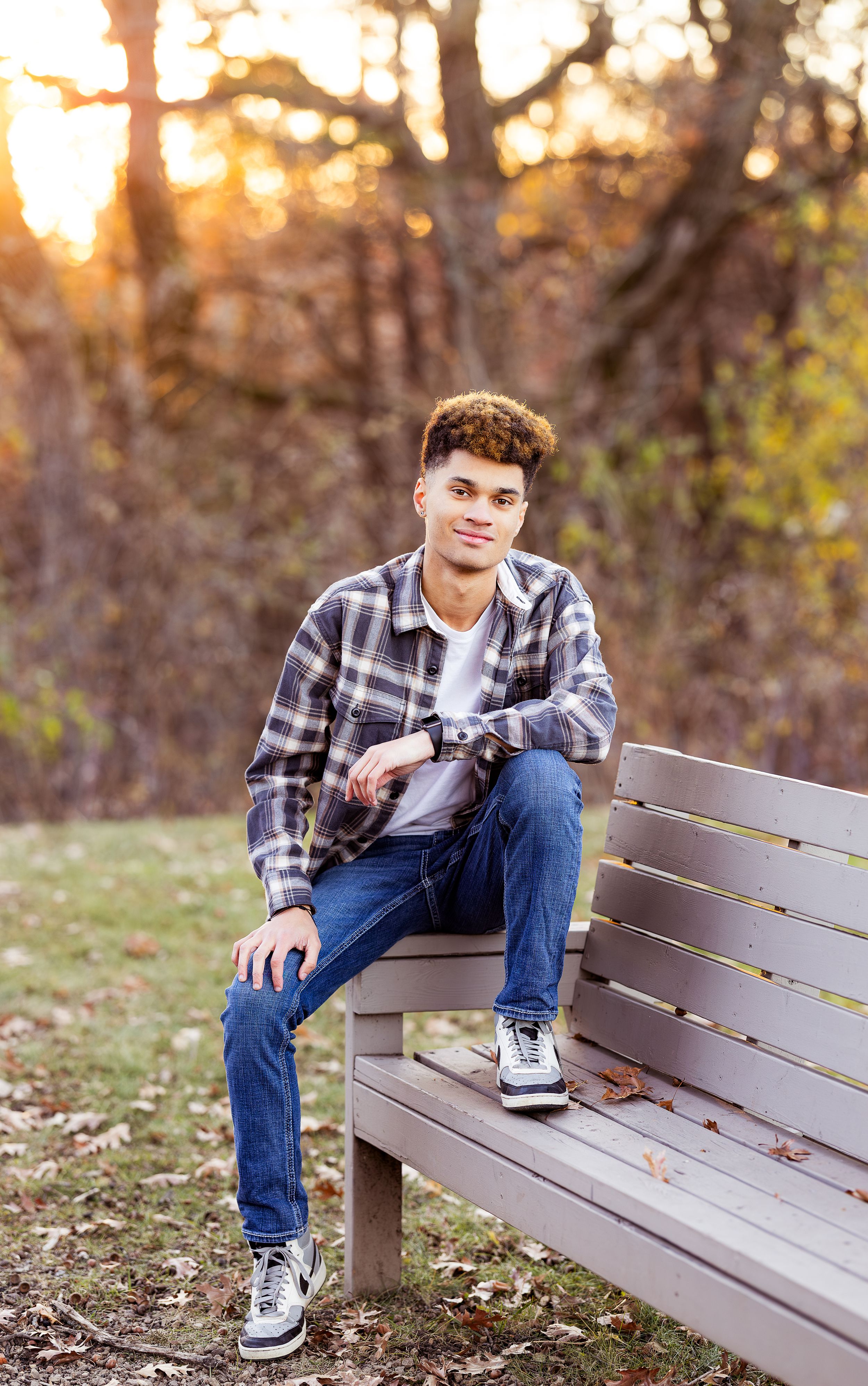 Casual outdoor portrait series on wooden bench with autumn foliage and warm sunset lighting in background.