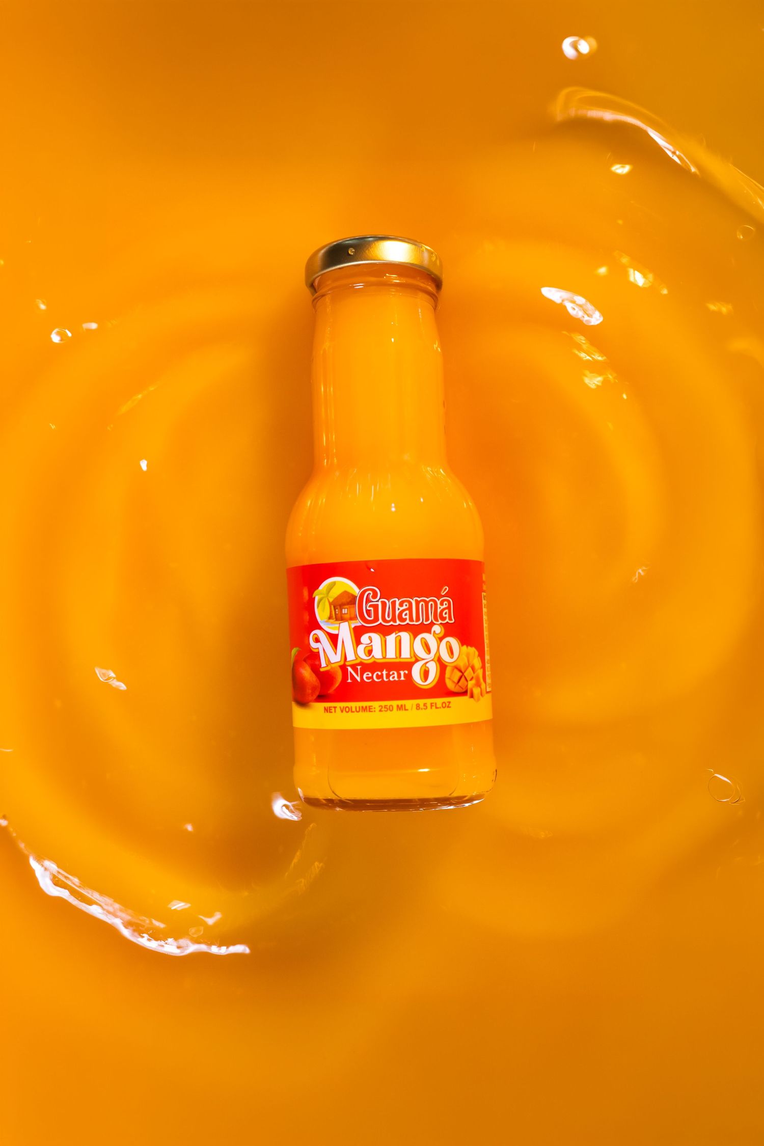 Glass jars of orange juice splash into a vibrant orange liquid background creating a dynamic product display.