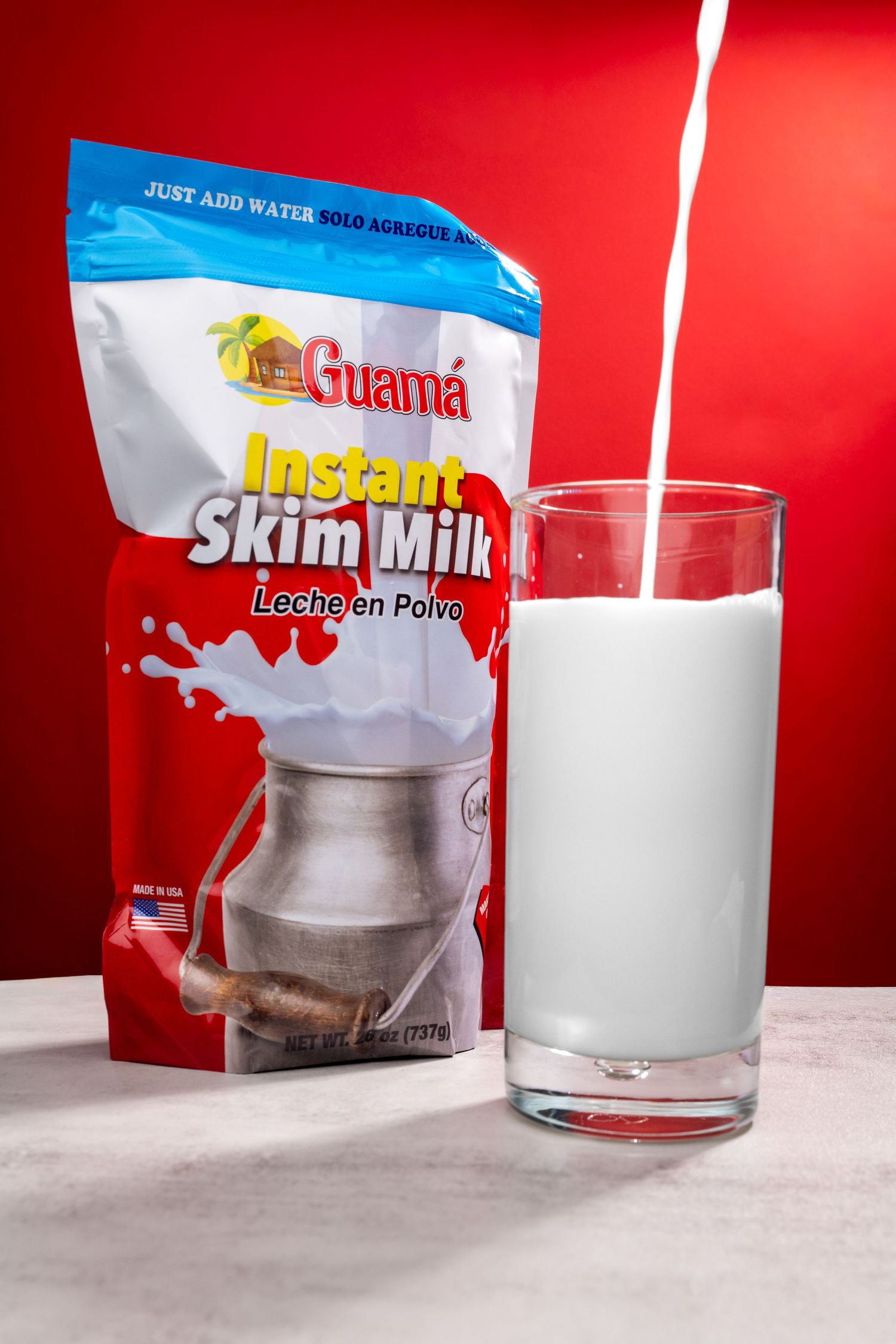 Sequence of instant milk powder being mixed with water in glass showing reconstitution process against red background.