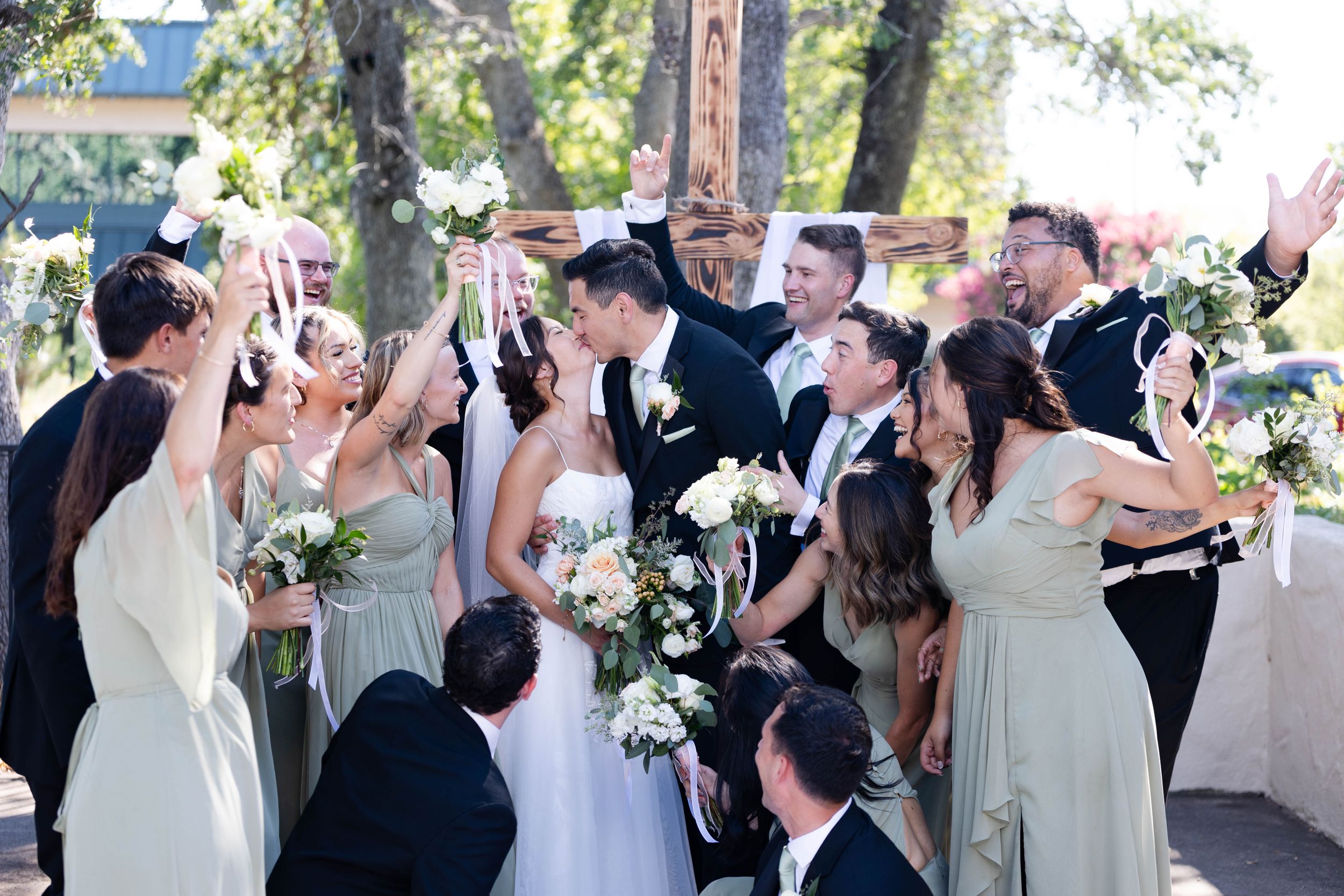 Bride and Groom with wedding party celebrating at lakeside pavilion in Chico, California