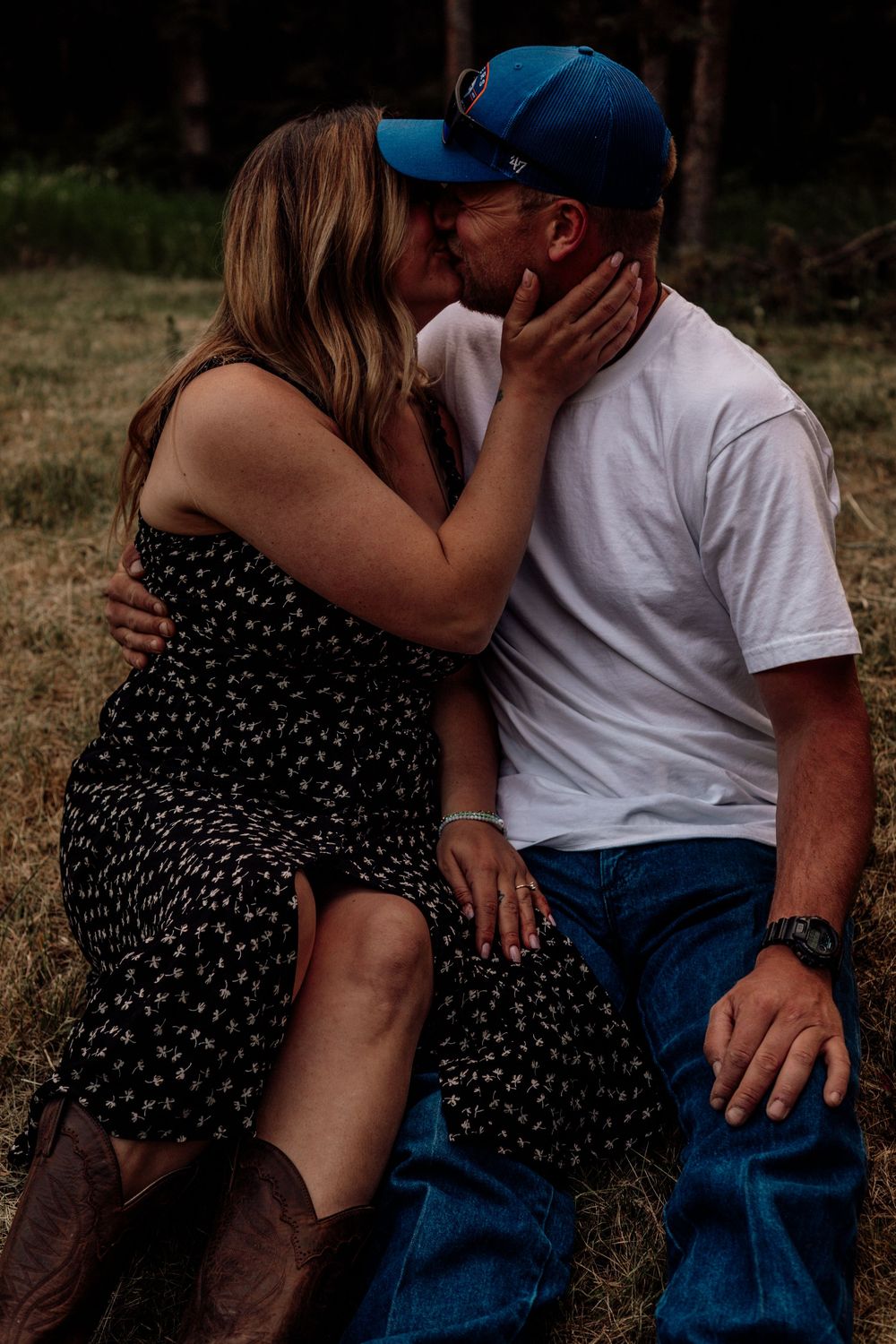 Romantic couple in white shirt and polka dot dress shares an intimate moment in an outdoor setting.