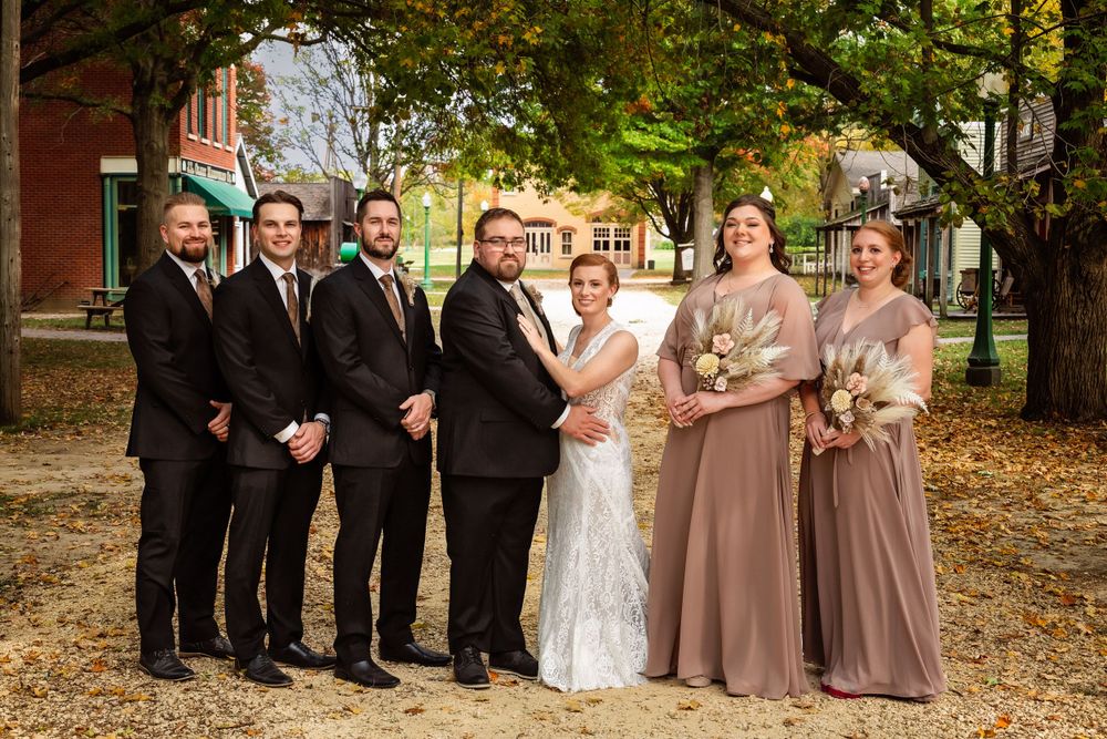 Wedding party in formal attire posed together under autumn trees.
Janesville, WI
Brodhead, WI