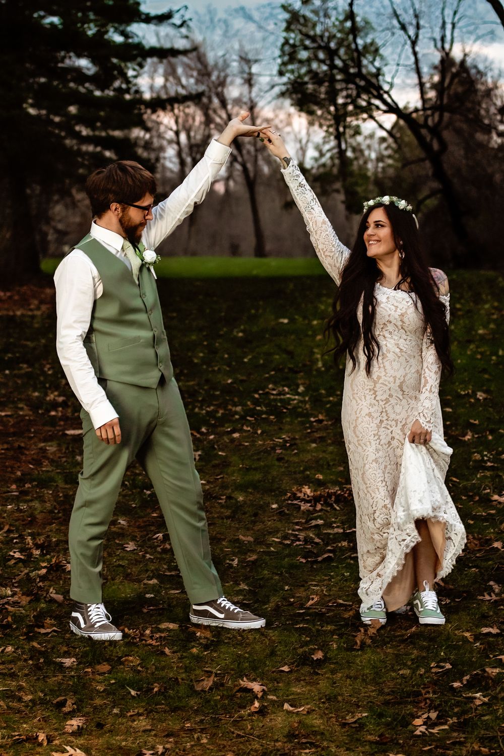 Wedding couple dancing playfully outdoors with bride twirling in lace dress.
Janesville, WI
Brodhead, WI
