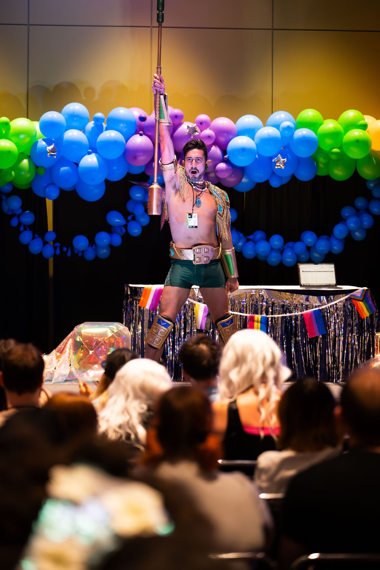 A cosplayer poses on stage at the Pride Lounge at C2E2 dressed as Namor