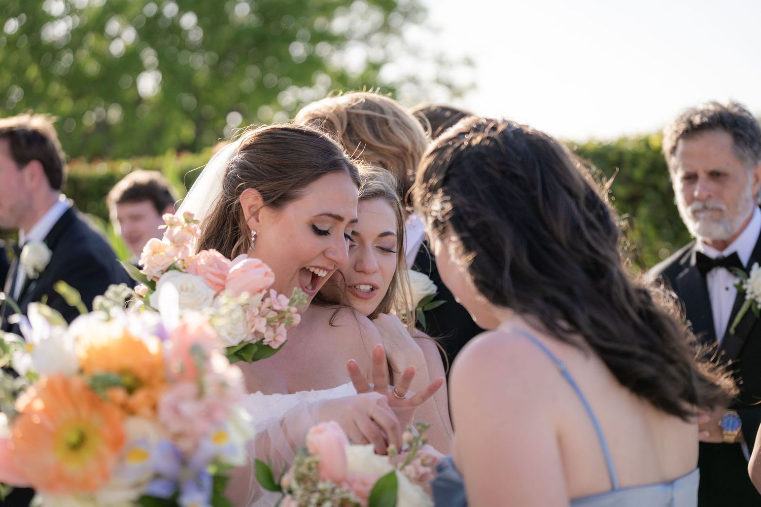Bride embracing a guest after her ceremony on the North Terrace at the Mansion at Tuckahoe
