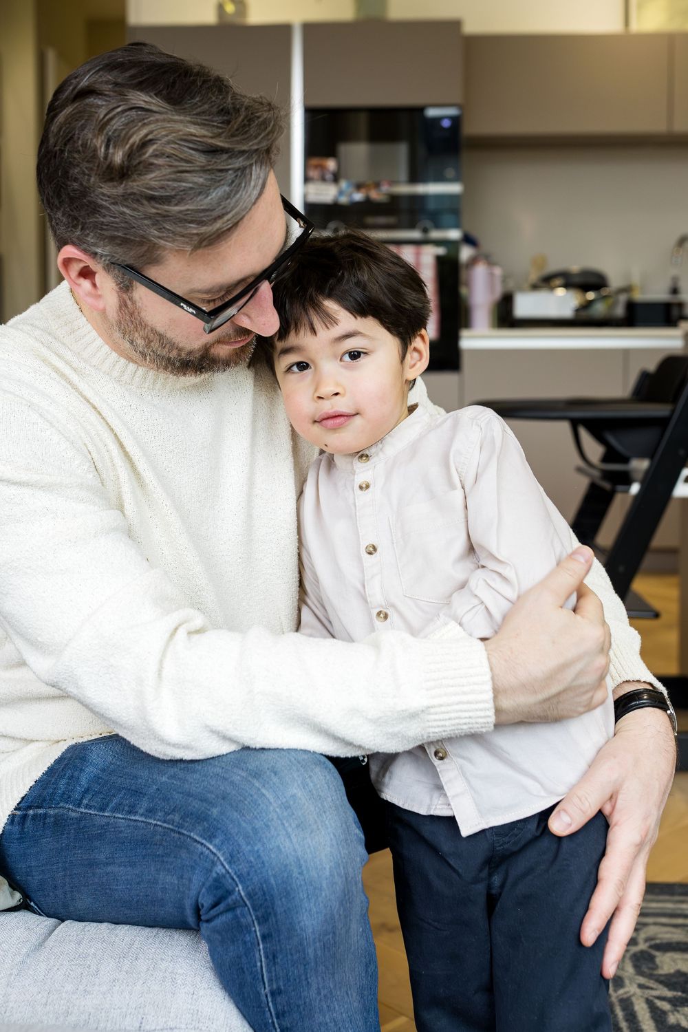 dad hugging his toddler son