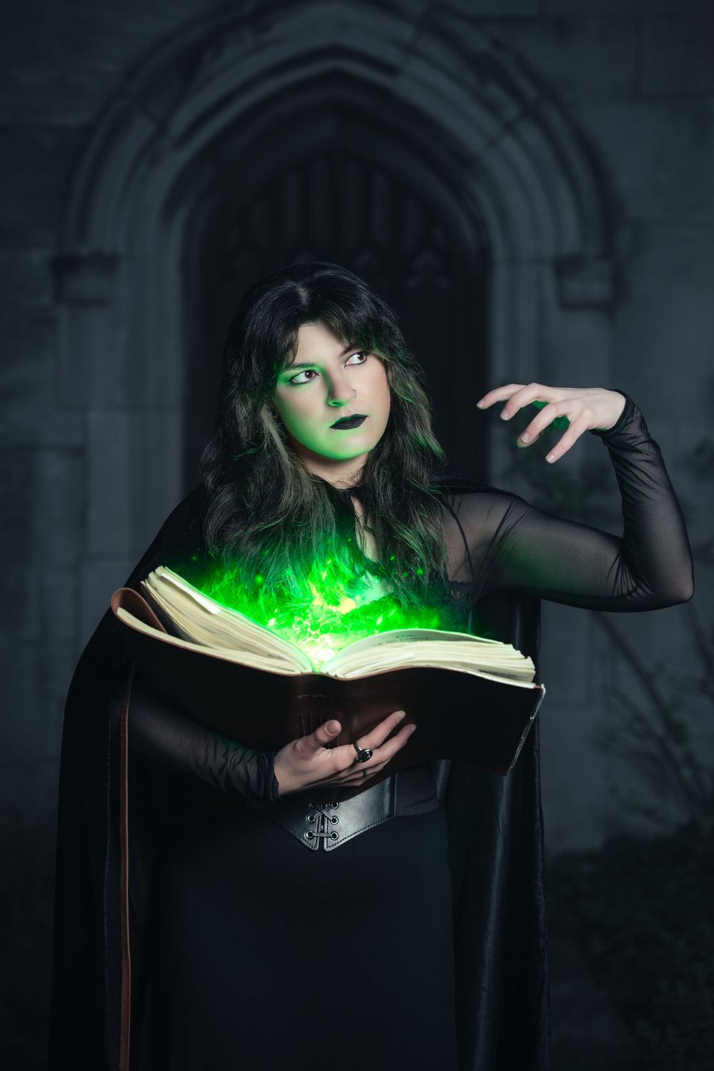 Dark fantasy witch casting glowing green magic inside a gothic archway.