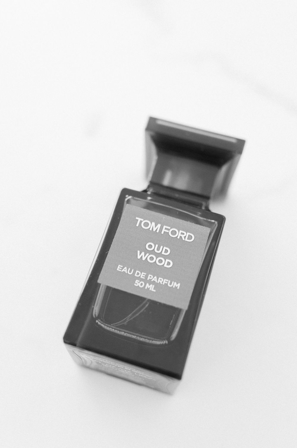 Tom Ford Oud Wood Eau de Parfum 50ml fragrance bottle in black and white photography.