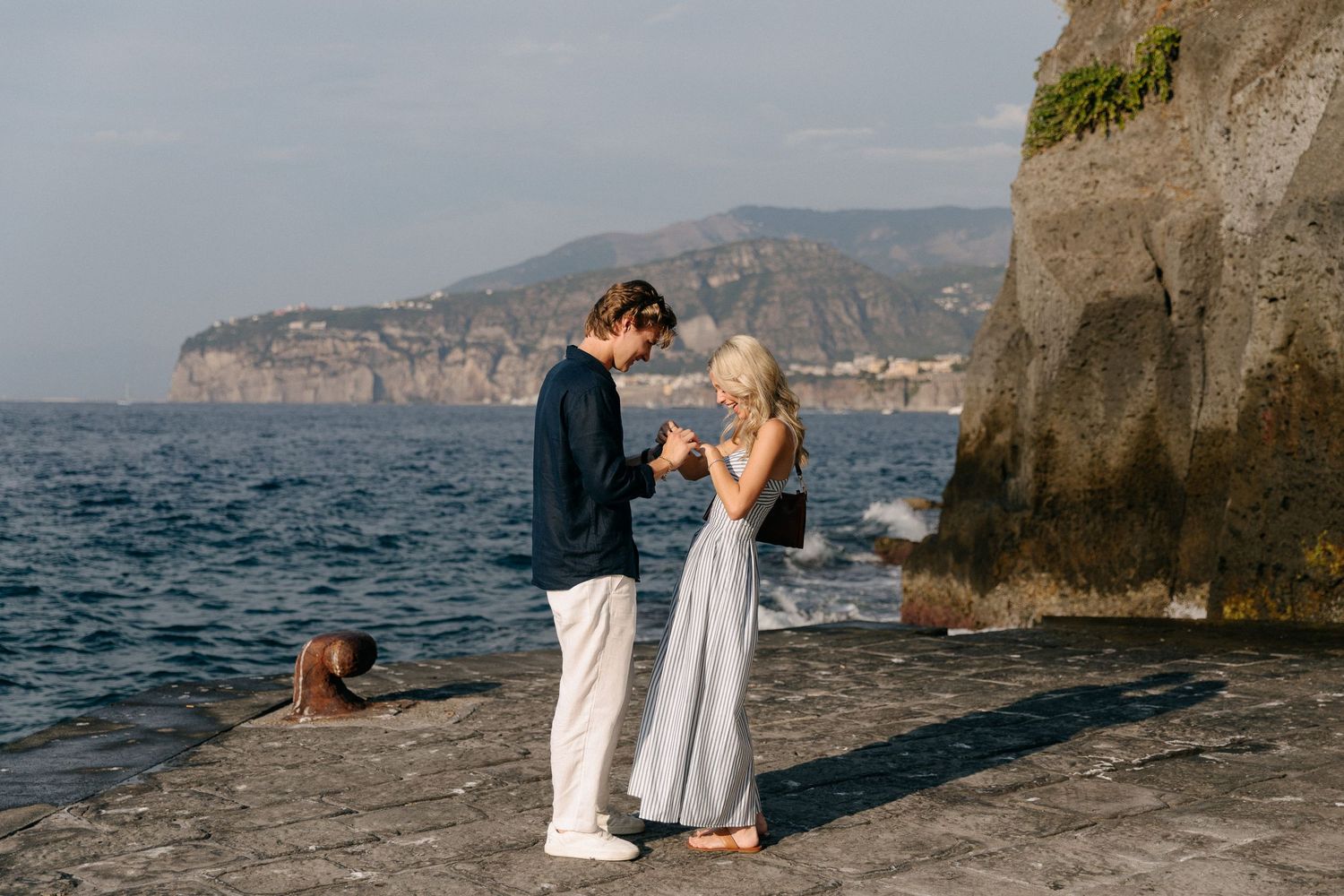 A man proposing to a woman in MArina Grande of Sorrento, ring moment