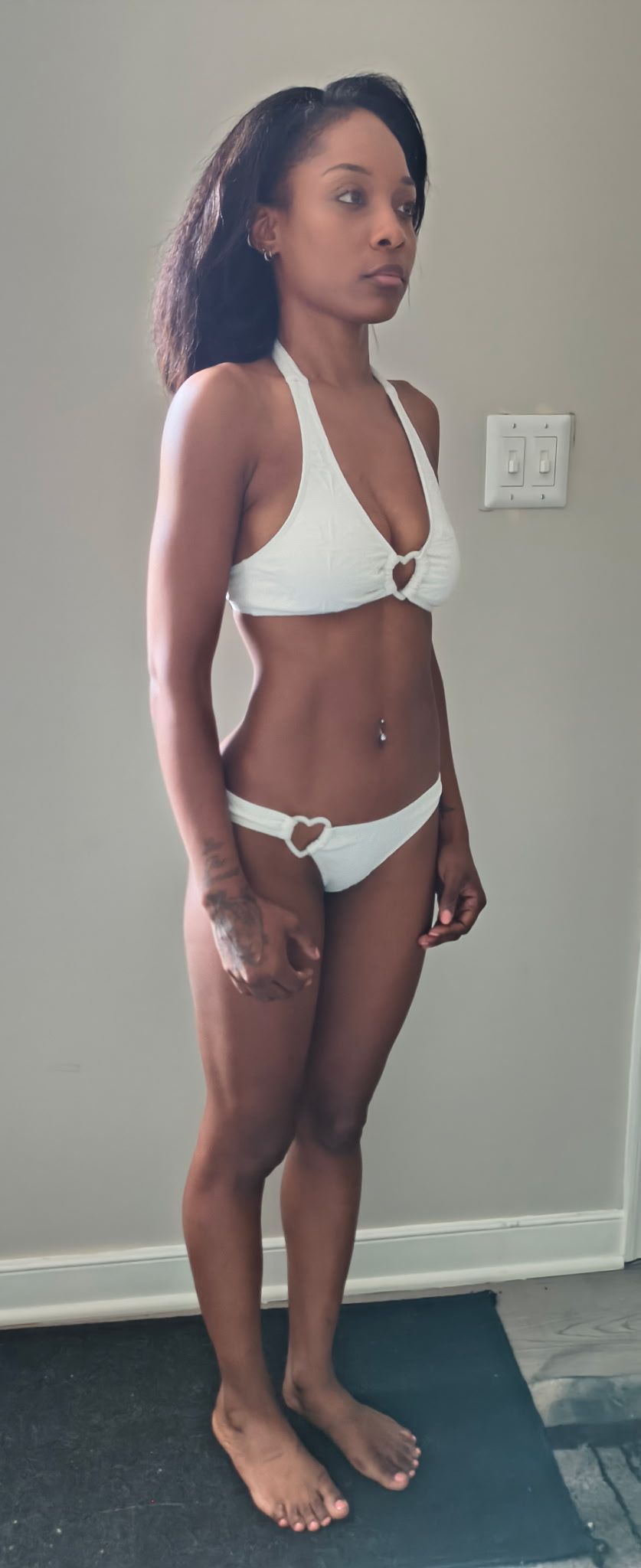 Three-quarter (right) swimsuit digital of Genesis Dudley wearing a white bikini.