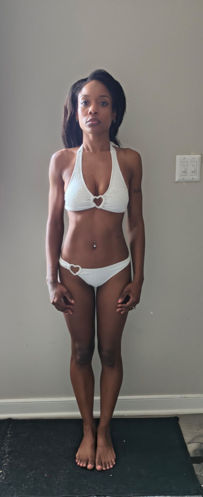 Full-length swimsuit digital of Genesis Dudley wearing a white bikini.
