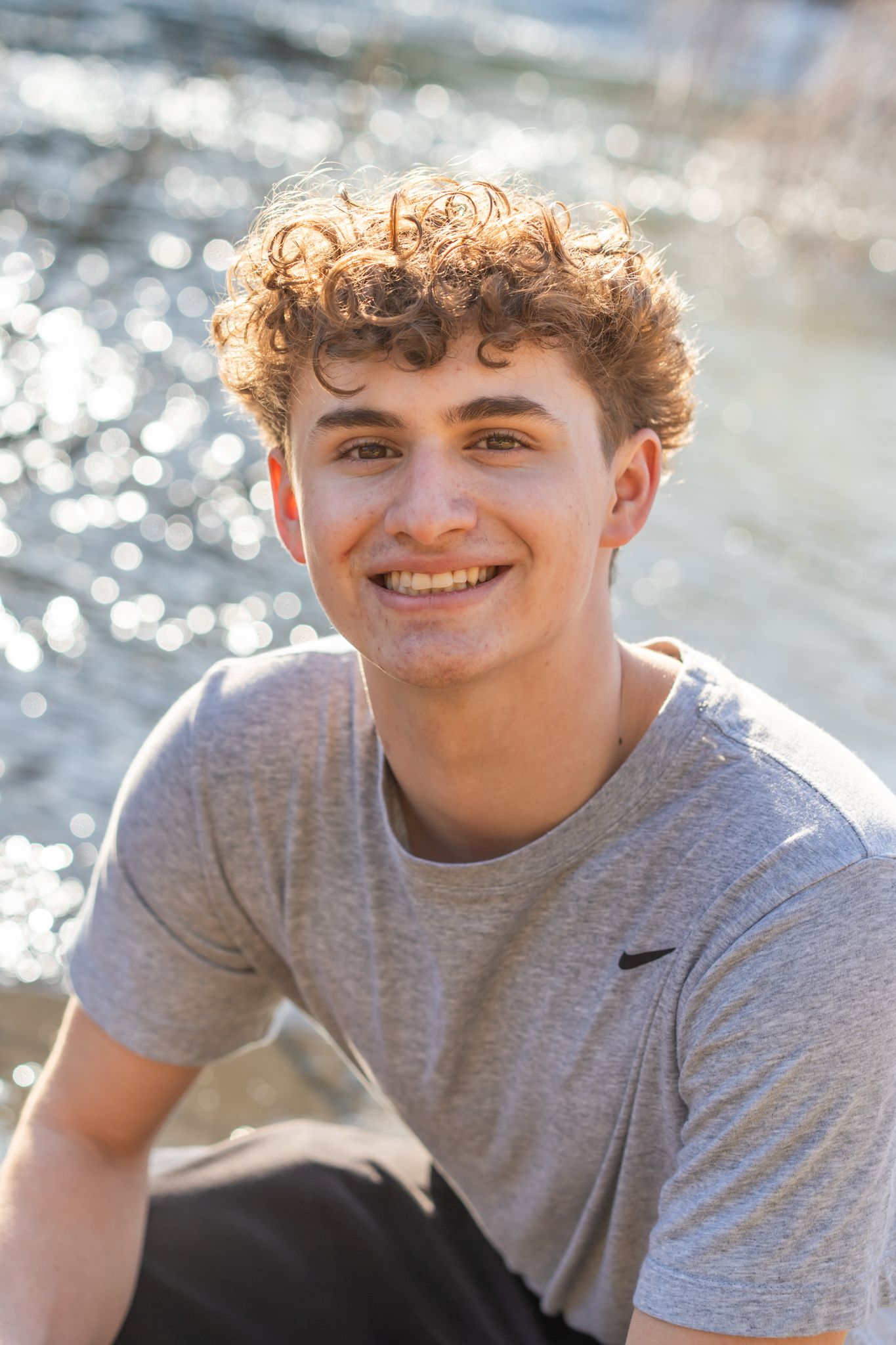 Close up senior portrait of a guy by the river