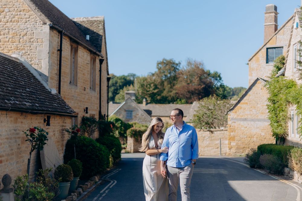 Newly engaged couple beside the River Eye in Lower Slaughter.