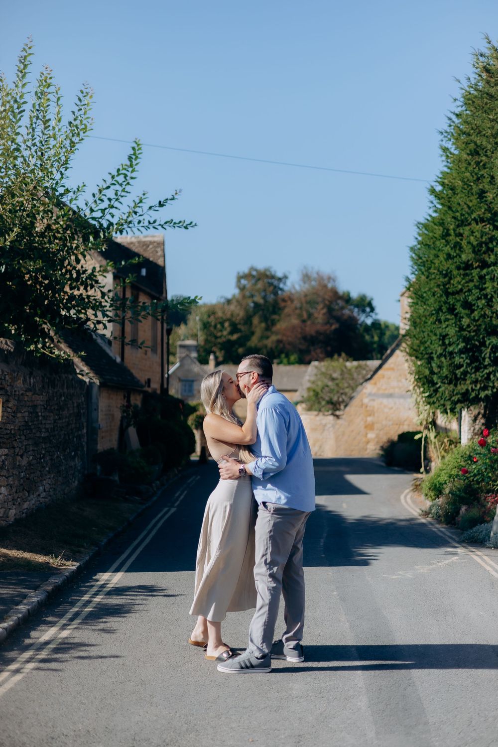 Newly engaged couple beside the River Eye in Lower Slaughter.