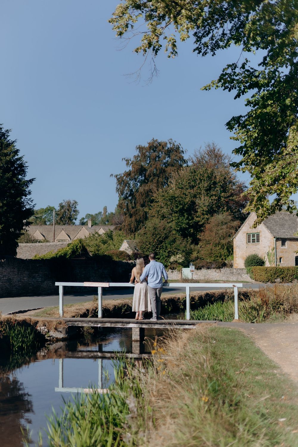 Couple laughing during a Cotswolds engagement photoshoot.