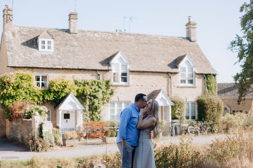 Engaged couple exploring Lower Slaughter after their proposal.