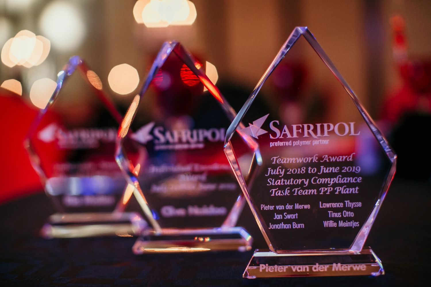 Crystal diamond-shaped Safripol Teamwork Award trophies displayed on a table at a corporate awards ceremony.
