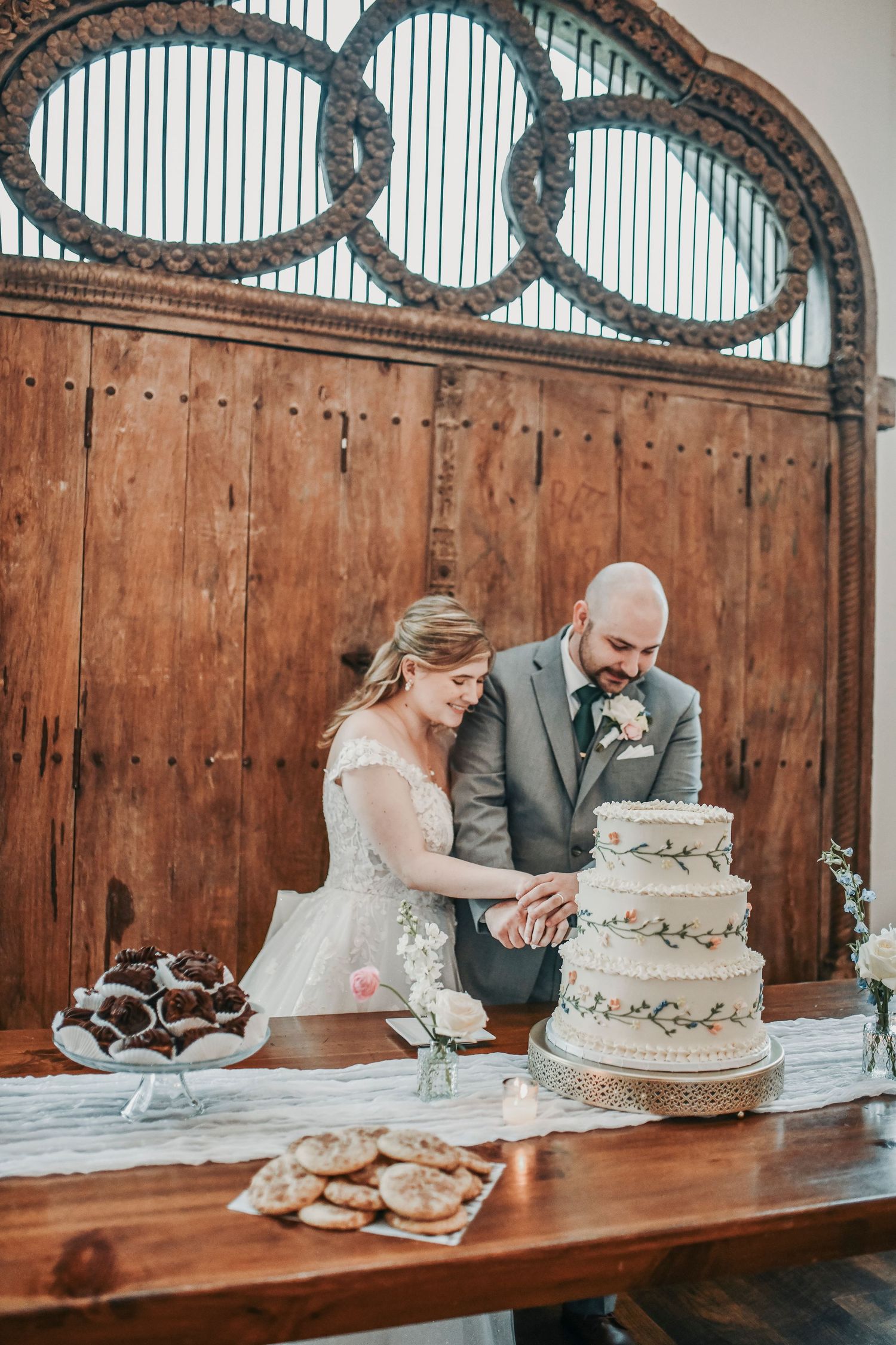 Parker and Kathryn cutting their wedding cake during their reception