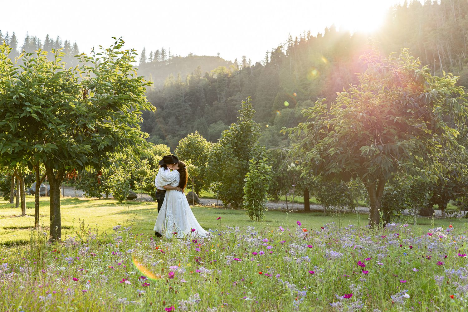 Bride and groom kissing in a wildflower meadow at Hydrangea Ranch in Tillamook Oregon.