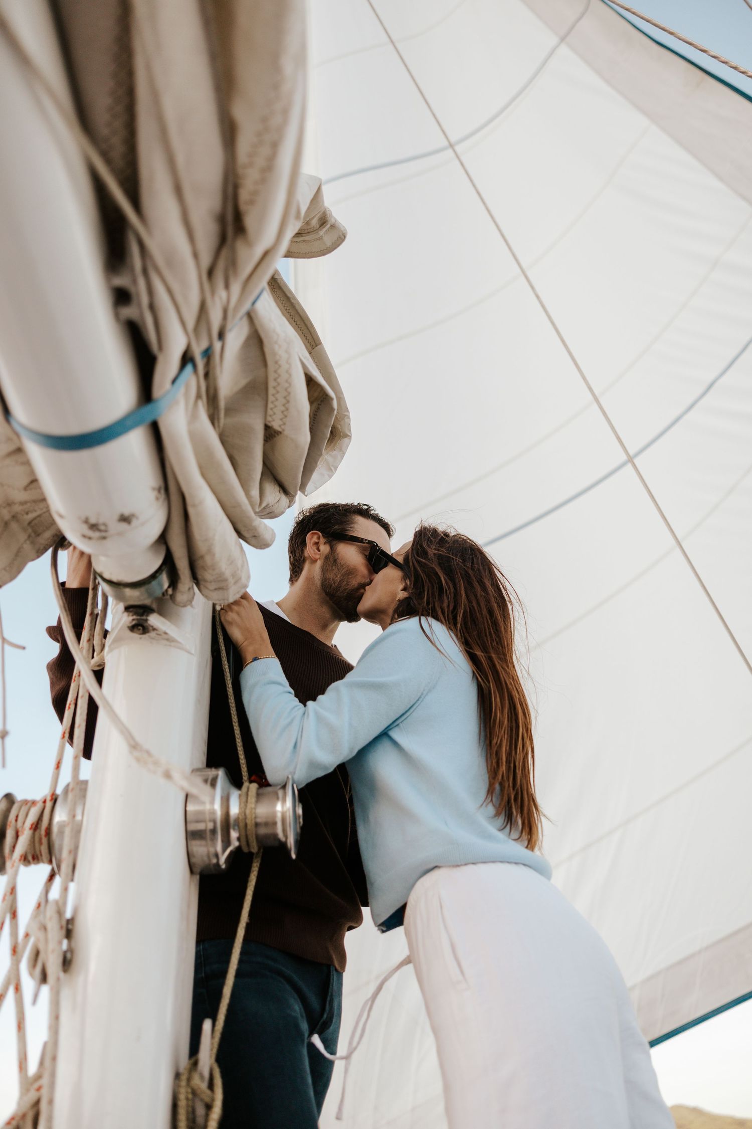 couple kissing on sailboat during elopement day in san francisco bay off of sausalito