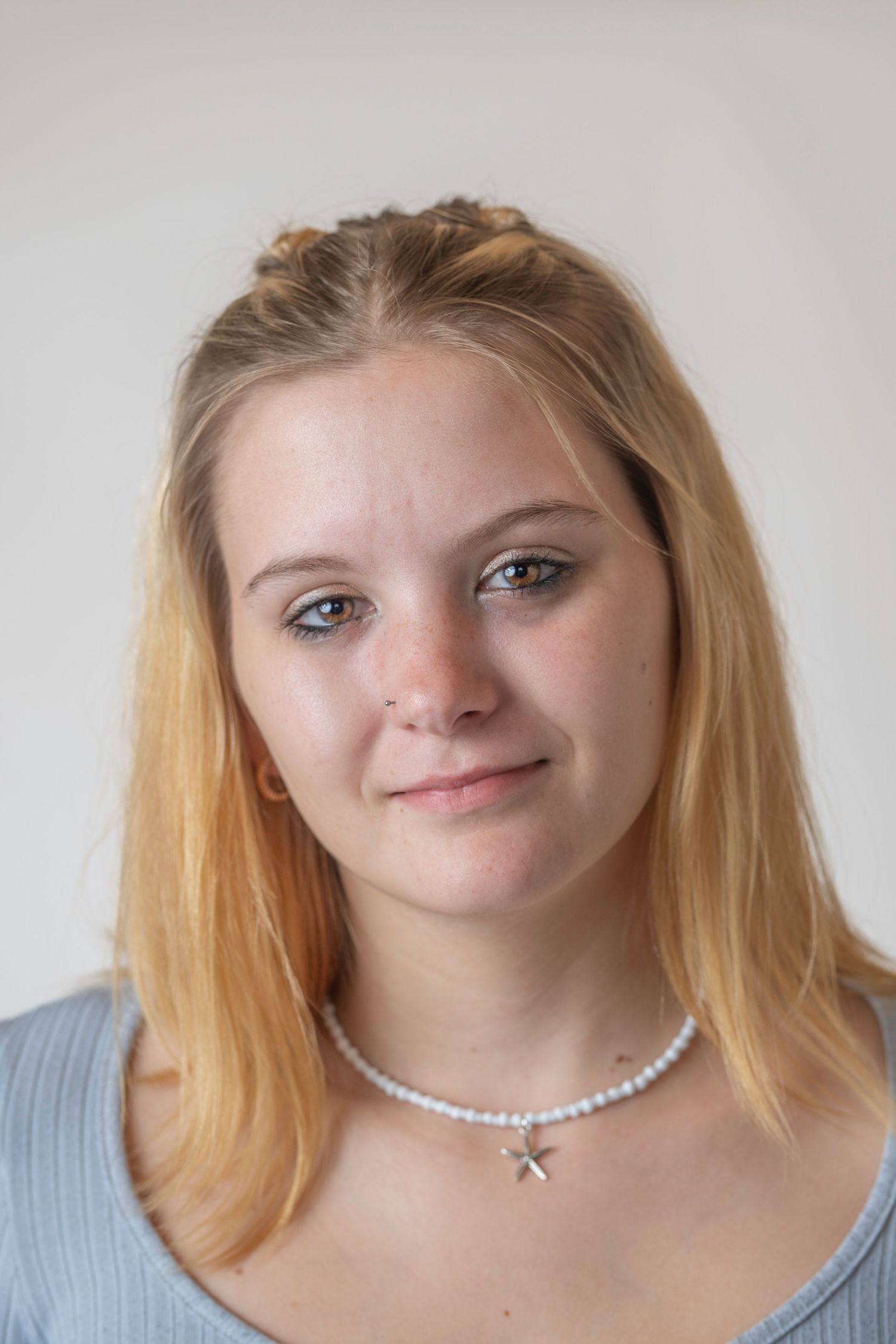 Natural professional headshot of a young woman photographed in studio
