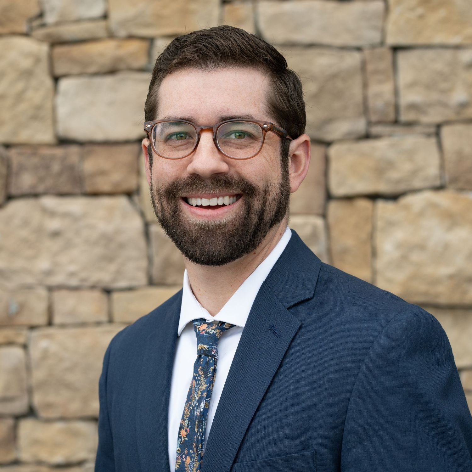 Outdoor professional headshot of a businessman in a suit and tie