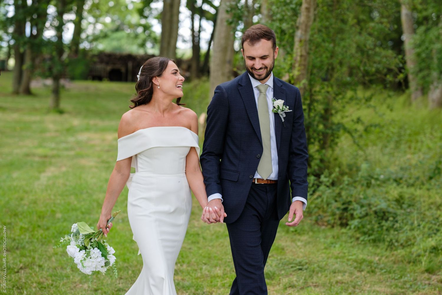 A series of black and white wedding photos showing a bride in a ballgown and guests at an elegant indoor reception.