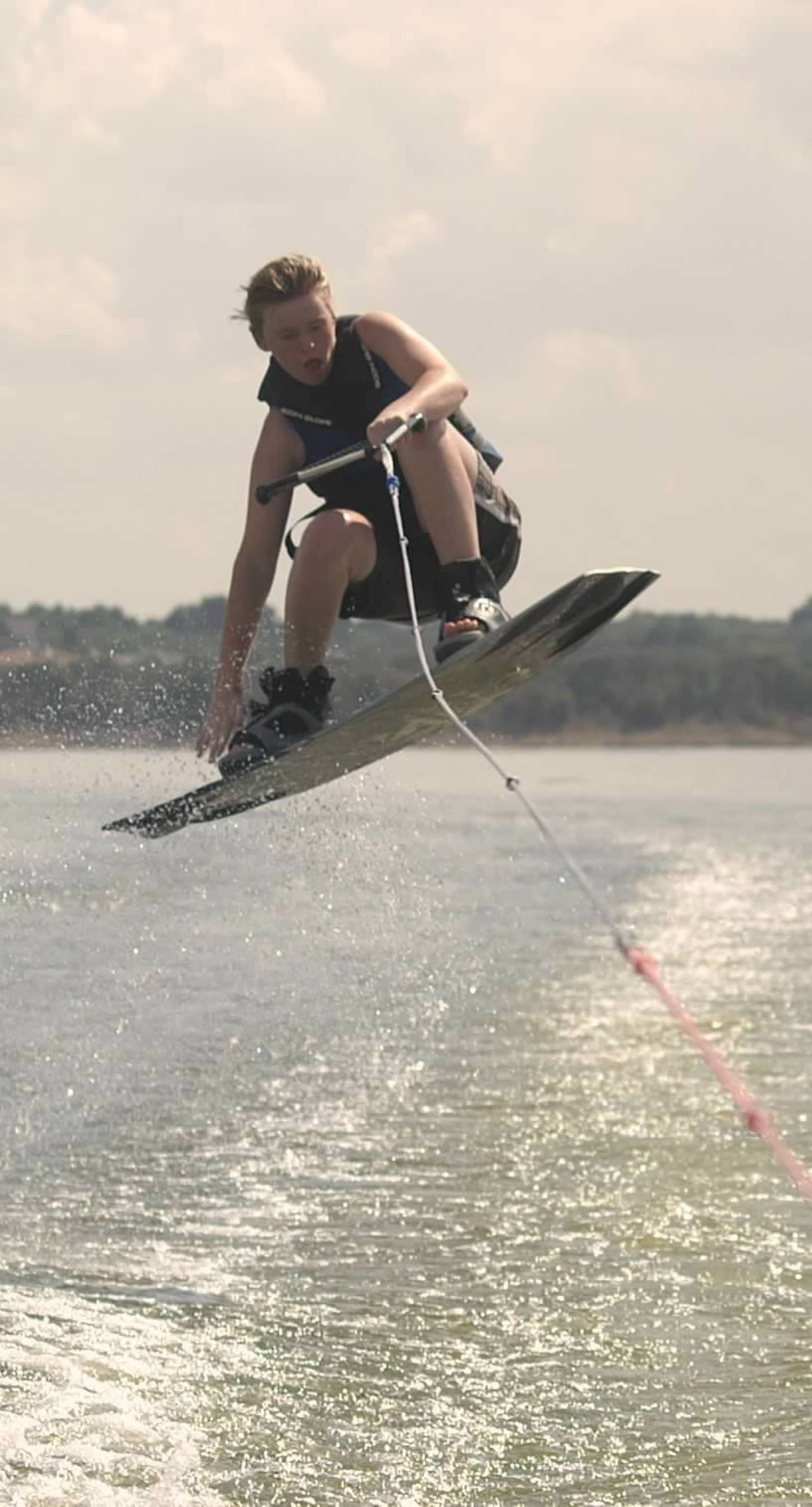 Teen boy gets air on wakeboard