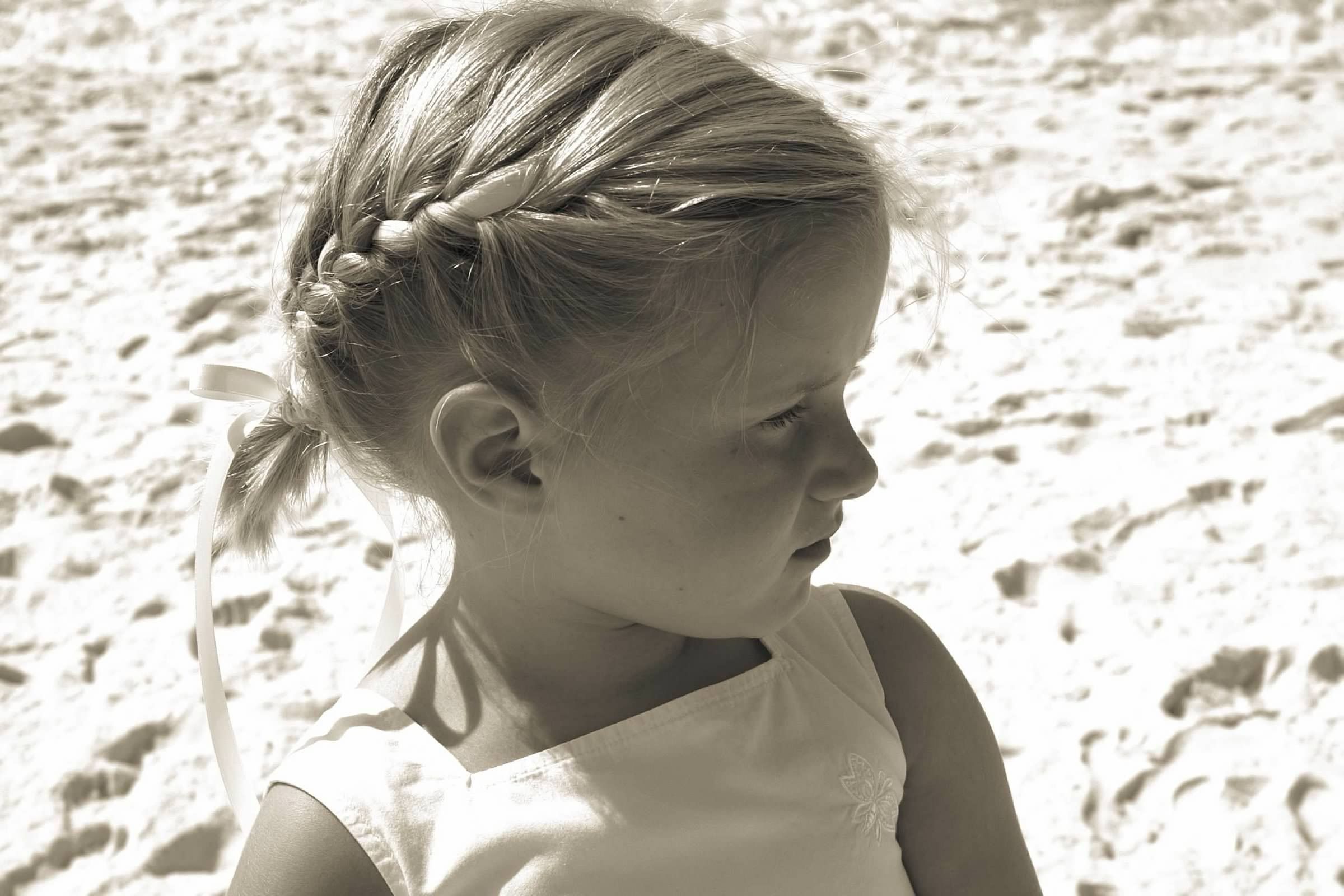 Young girl looks off while at the beach