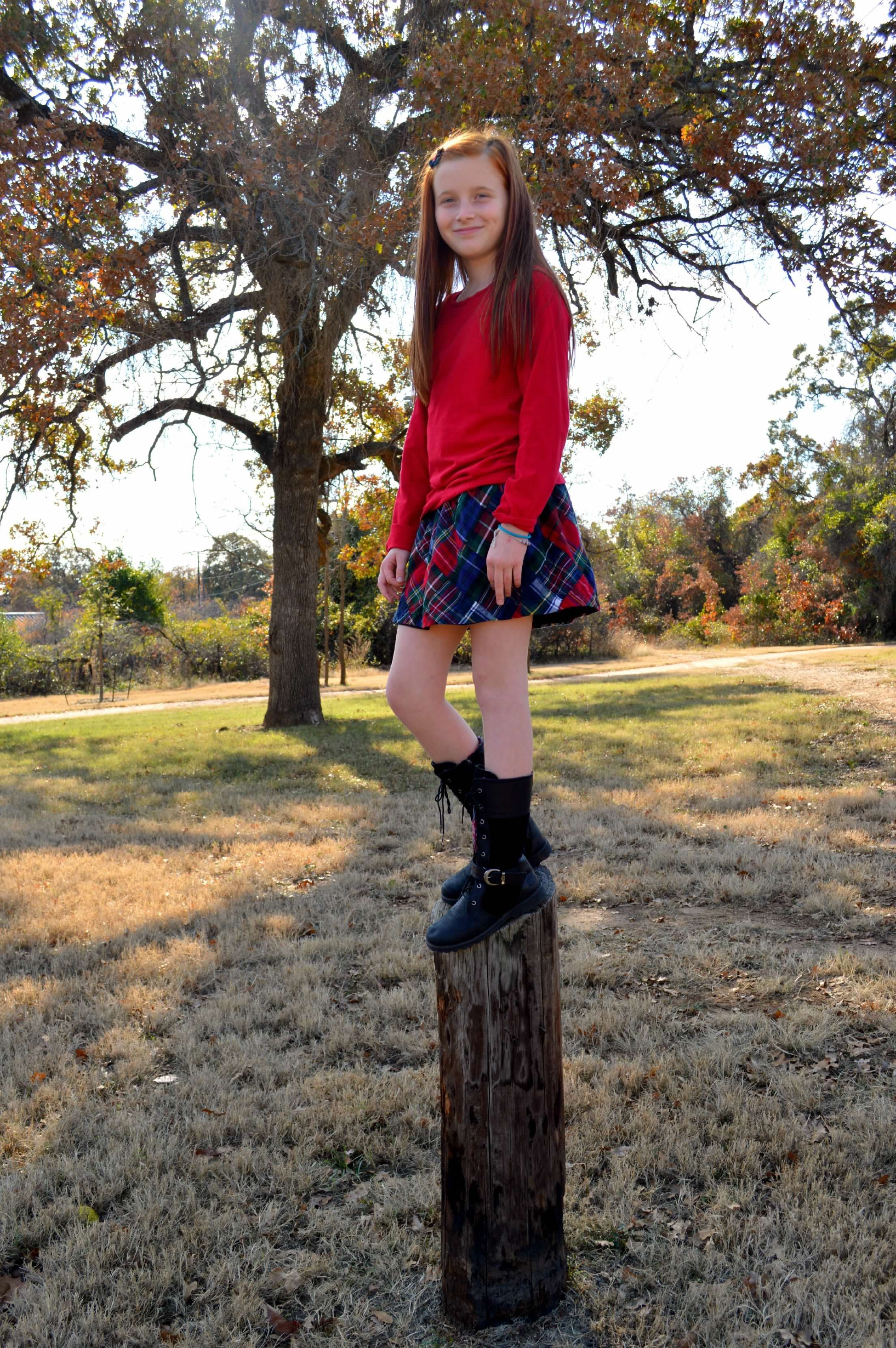 Young girl stands on post