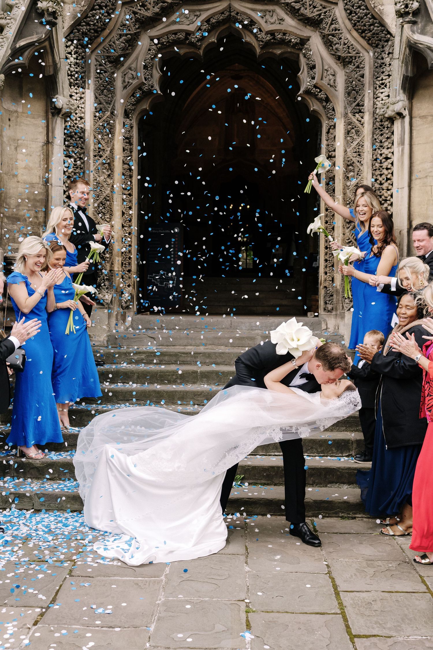 Groom dips bride for a kiss outside St Mary Redcliffe Church Wedding