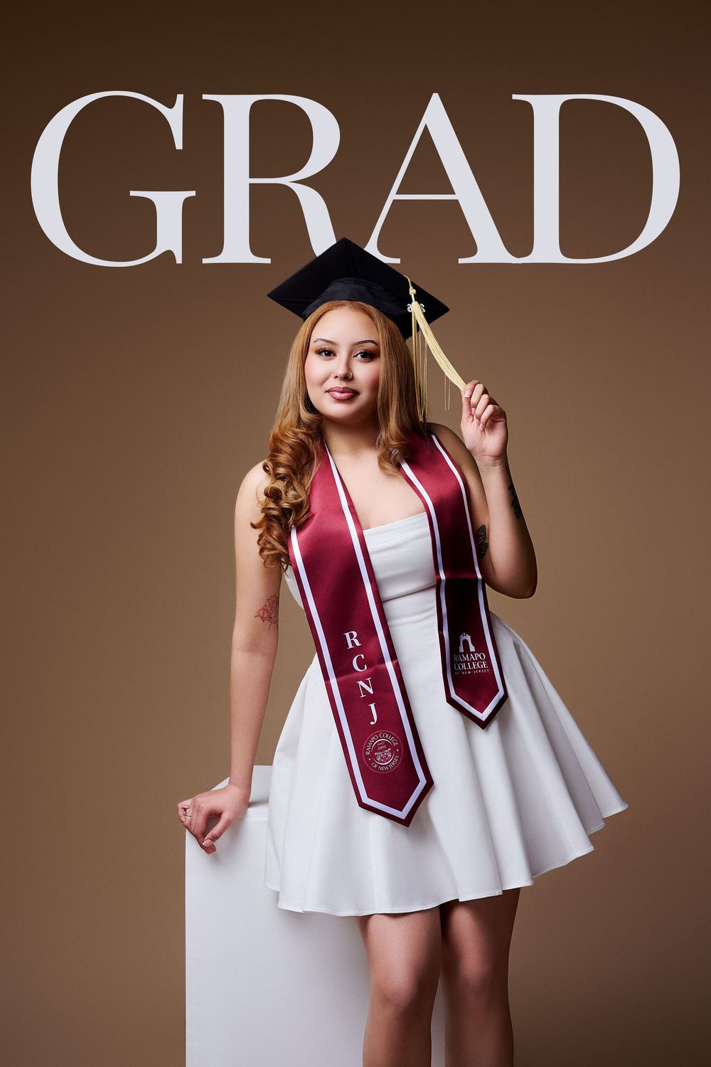 Magazine-style studio graduation portrait with "GRAD" text featuring an RCNJ graduate, by a North NJ portrait photographer.