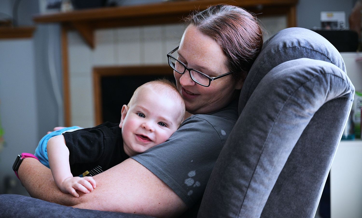 Mother sharing a candid moment at home with her smiling baby.