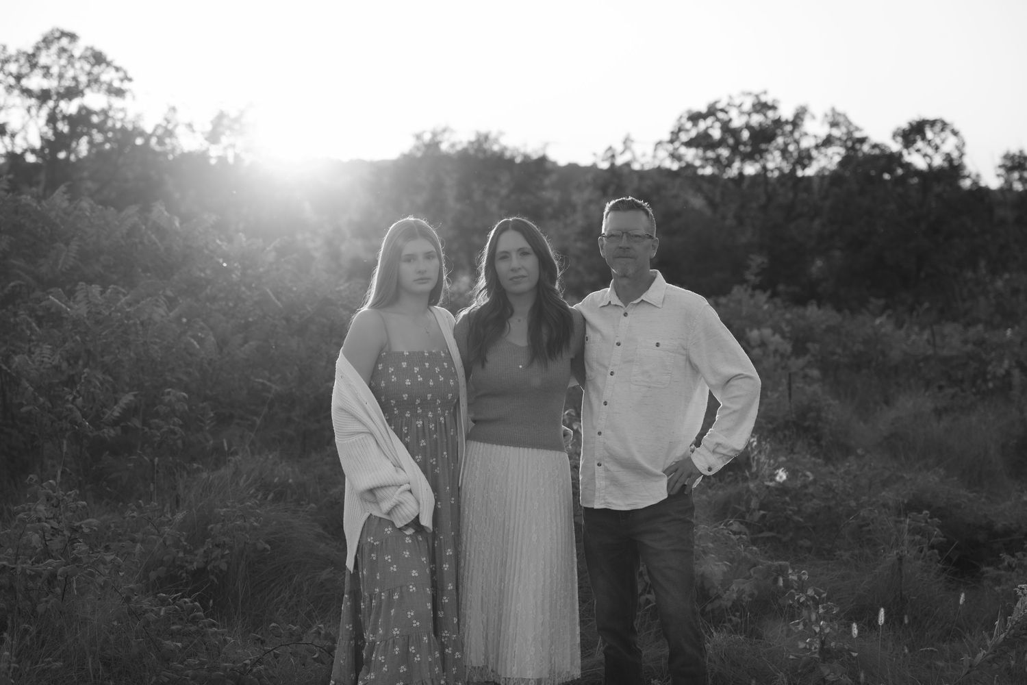 a black and white sunset portrait of a family of three during fall mini session in hudson wisconsin