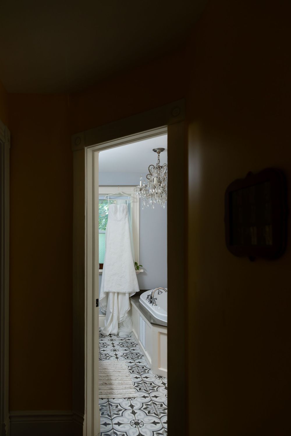 Bridal details and dress hanging in the bathroom on the morning of a wedding in london, ontario