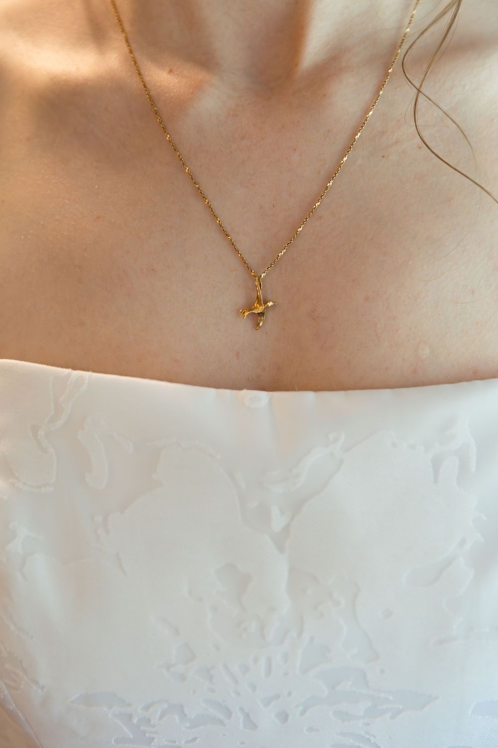 detail photo of brides necklace and dress neckline during the wedding day morning in london, ontario