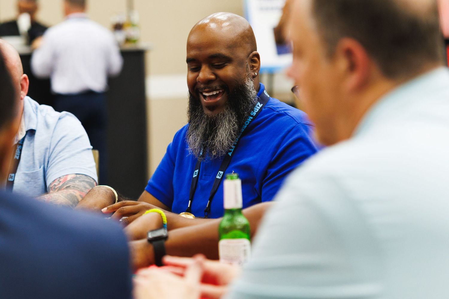 alt="Conference attendees laughing and networking together at Zips Car Wash corporate event in Orlando Florida"
