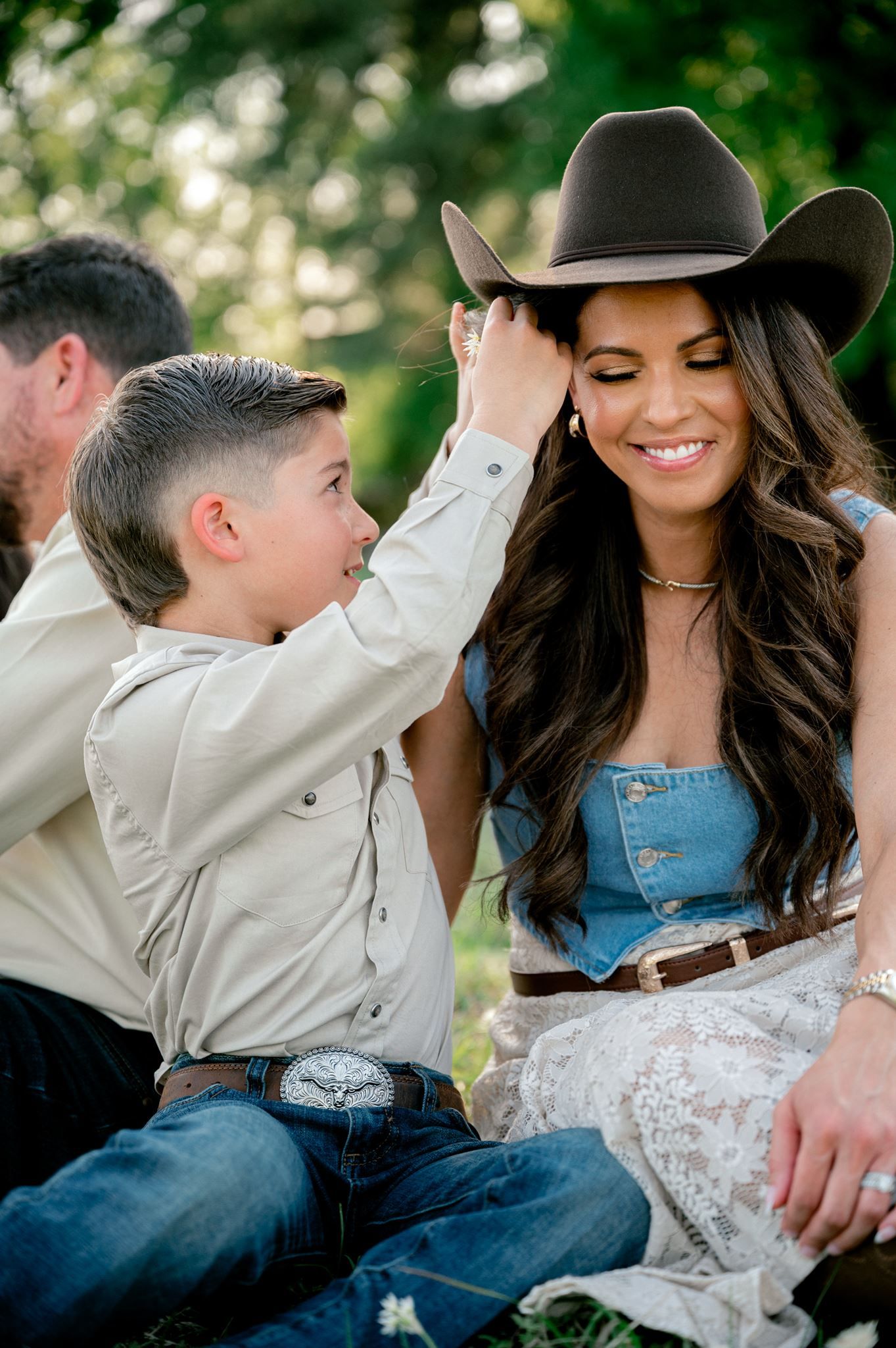 Son placing a flower in his mother's hair.