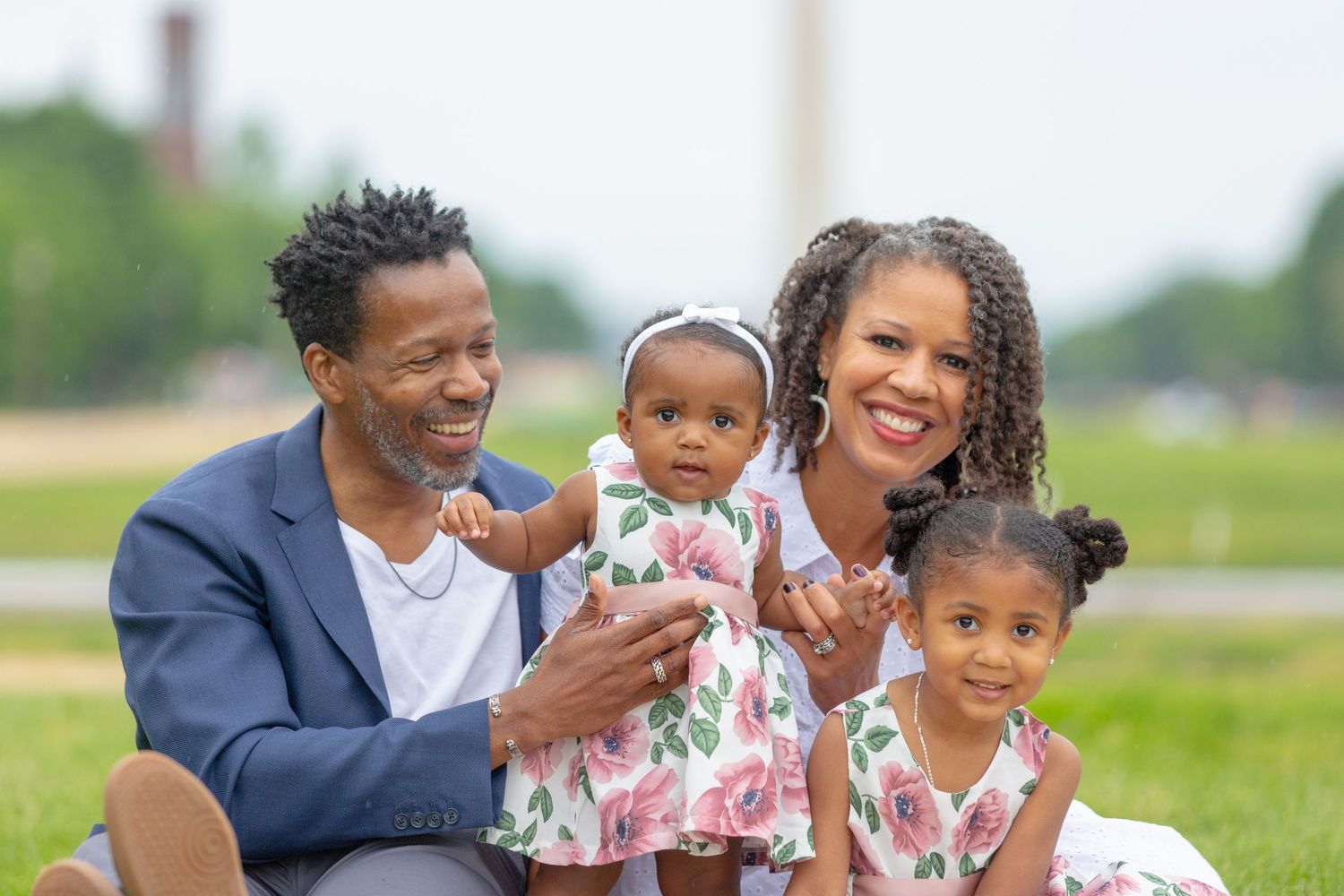 family with two children enjoying an outdoor portrait session.