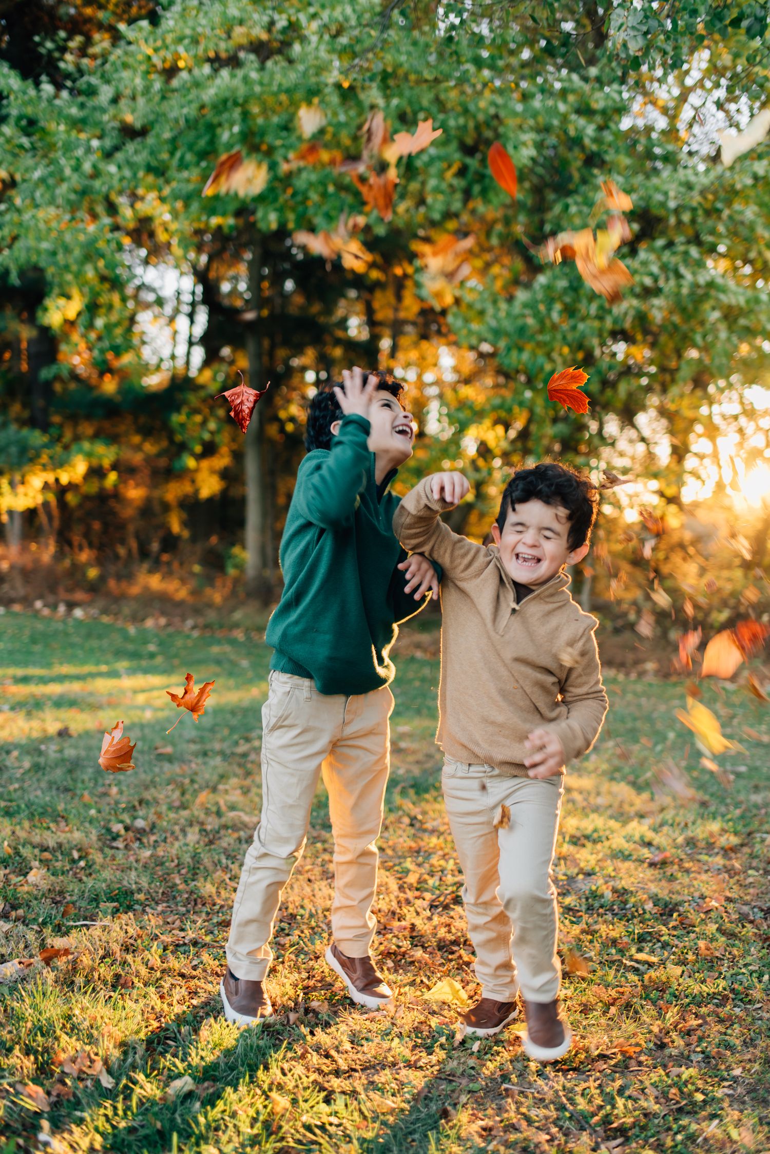Kids throwing leaves in fall foliage in Pittsburgh, PA